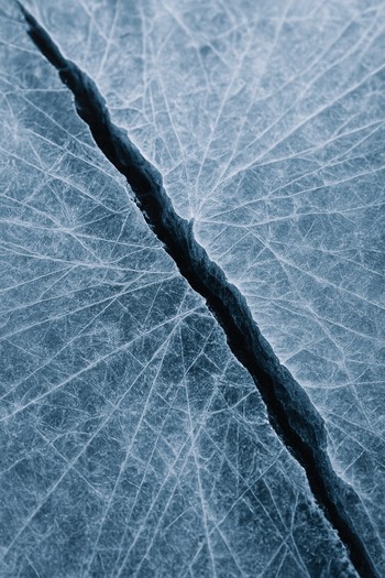 Close view of a long ice crack with light reflecting inside