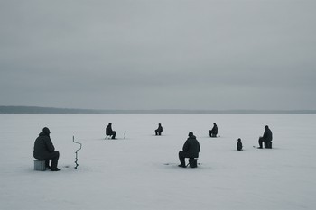Wide ice field with several anglers spread out in the distance